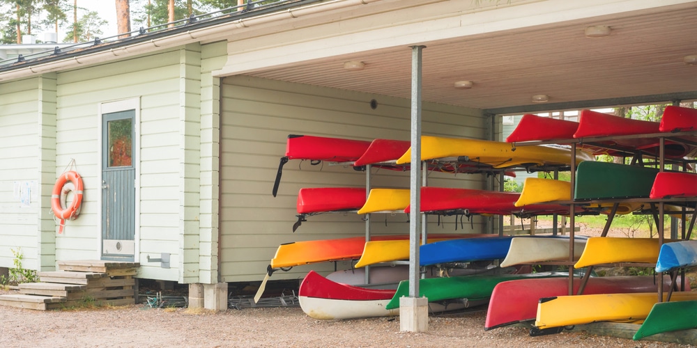 A view of kayaks stored on racks inside a garage