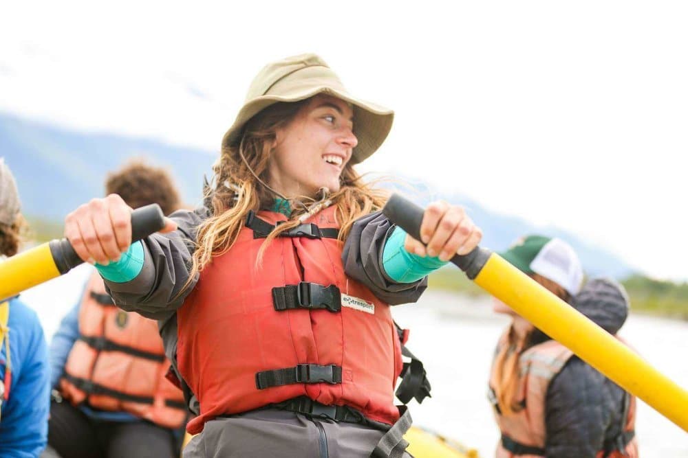 A close view of a happy woman paddling