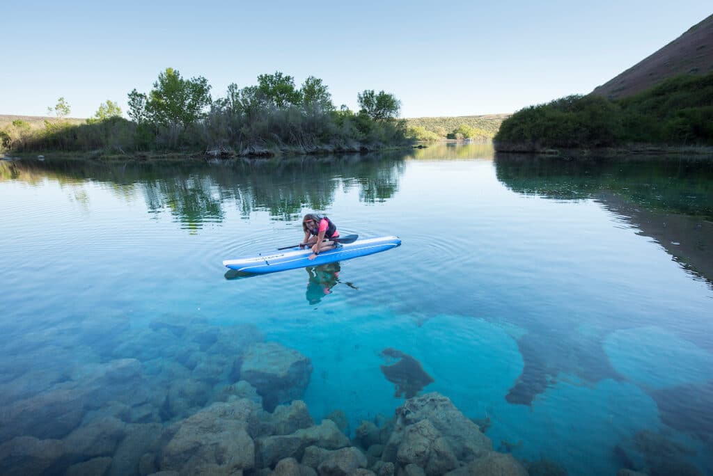 A person kayaking in the Blue Heart springs Idaho