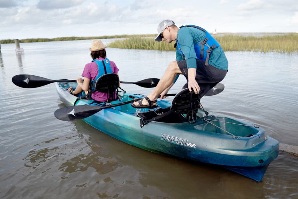 A person sitting inside a fishing kayak