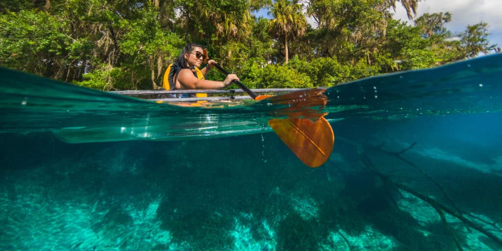 A woman kayaking in the blue sea of Rainbow springs state park