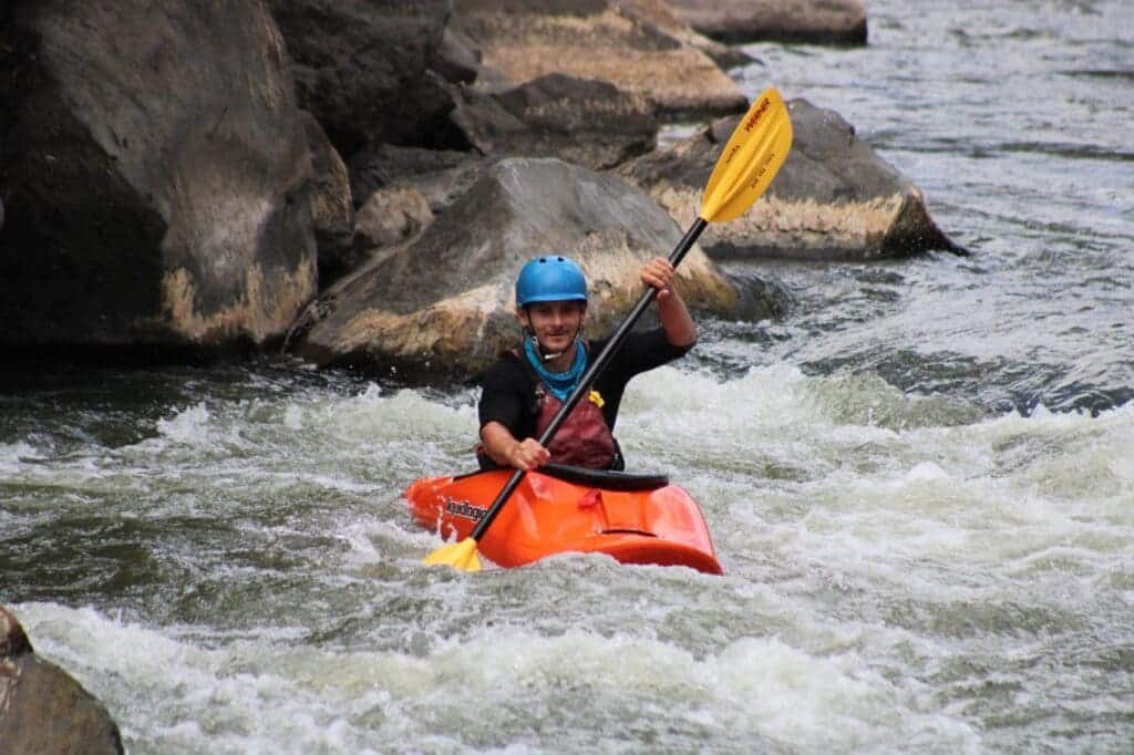 a boy kayaking in water