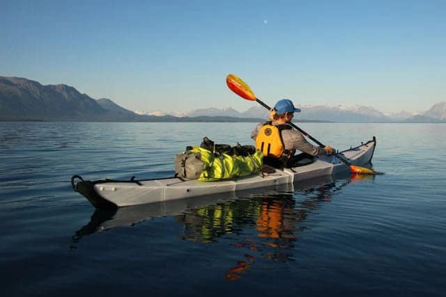 a person kayaking in fiberglass kayak