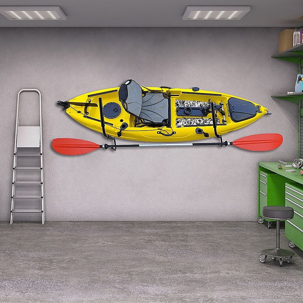 a yellow color kayak stored in a garage along with kayaking paddle