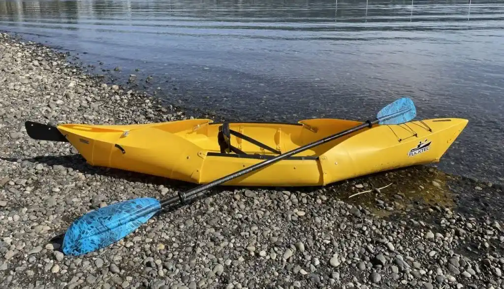 Tucktec Folding Kayak with a paddle on beach