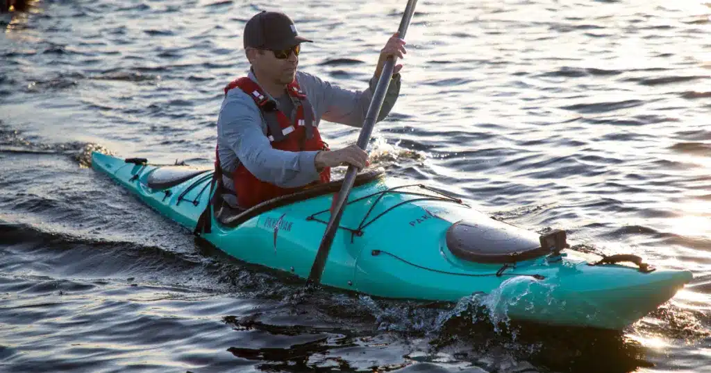 a kayaker kayaking in water on Pakayak Bluefin