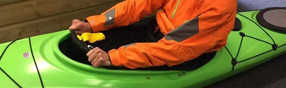 a kayaker sitting in cockpit of a kayak