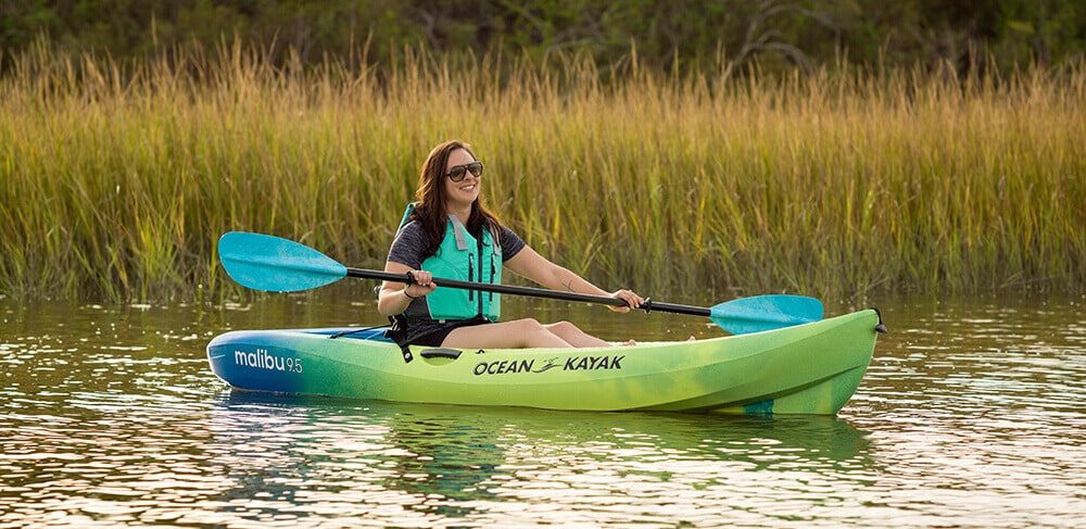 a lady paddling in a kayak