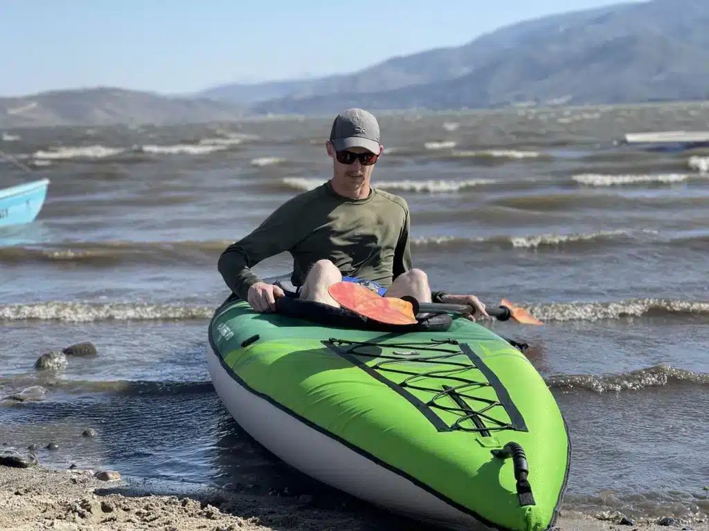 a lady kayaking in a white water kayak