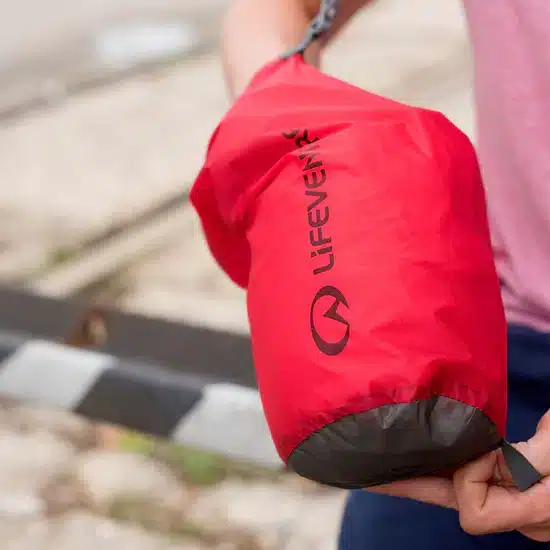 a man putting his hand inside a dry bag