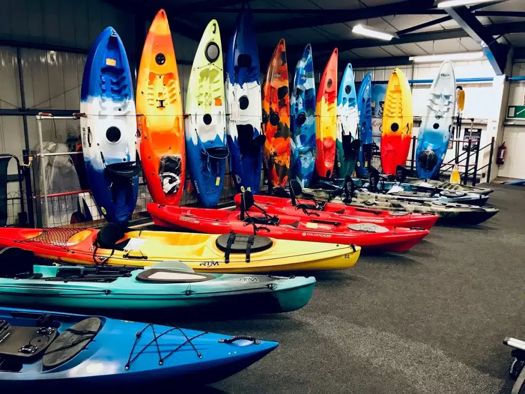 different types of kayaks in a storage