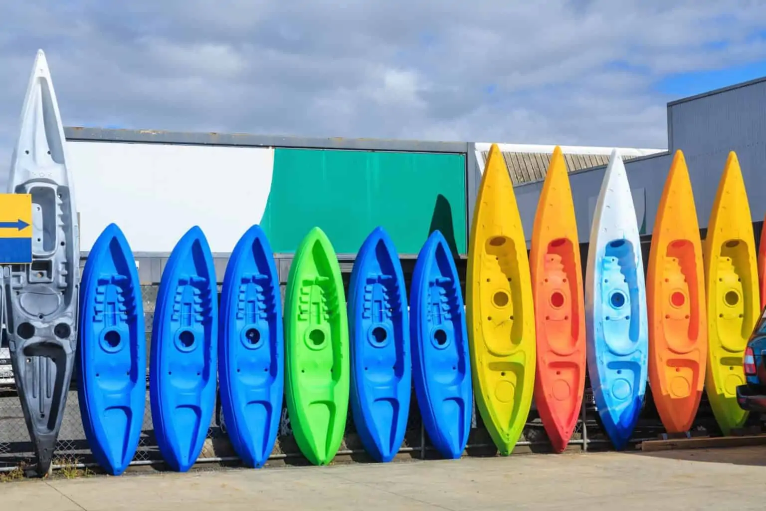 different ypes of kayaks standing in a row