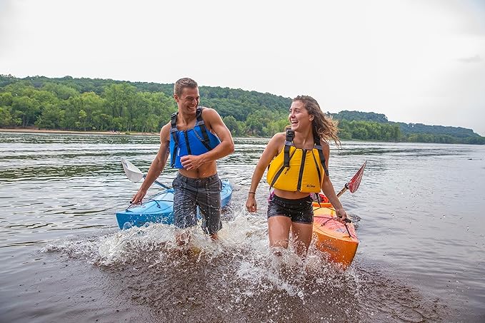 a man and a woman wearing Onyx MoveVent Dynamic Paddle Sports Life Vest