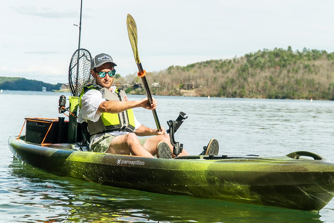 a paddler paddling on Perception Pescador Pro kayak