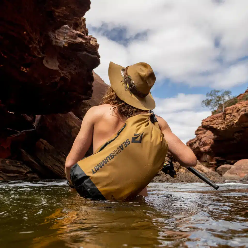 a tourist carrying Sea to Summit Big River Dry Bag  in water