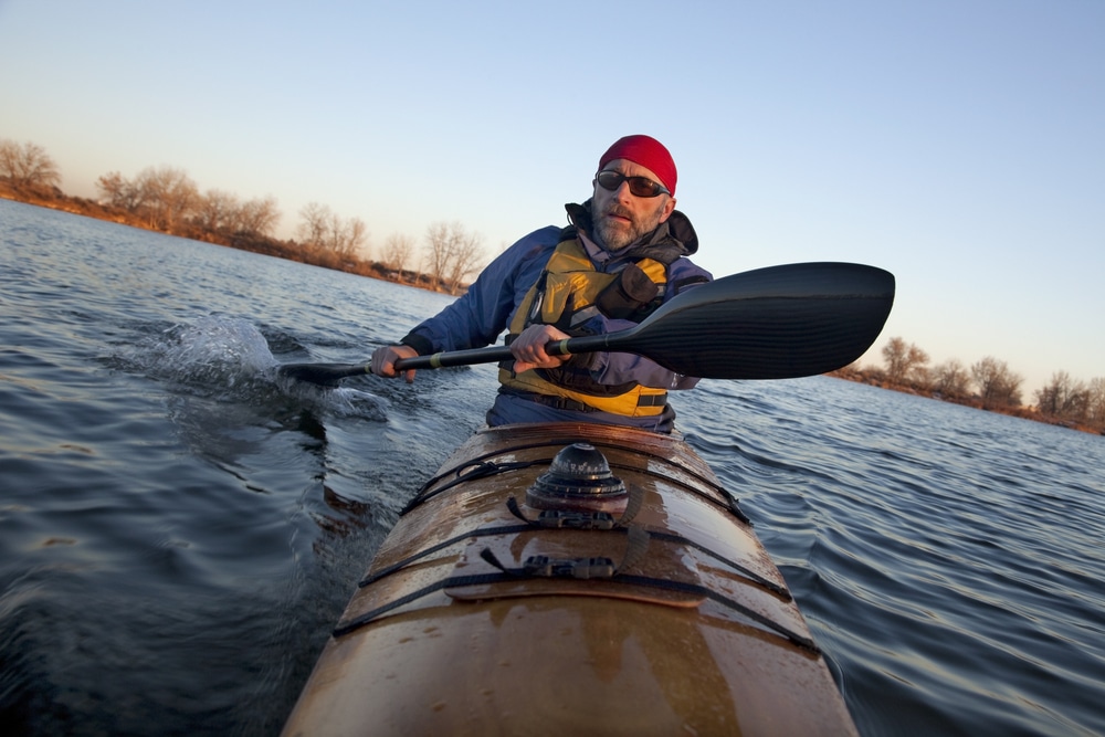 Mature Male Paddler Exercising (turning Boat Using Rudder Stroke With